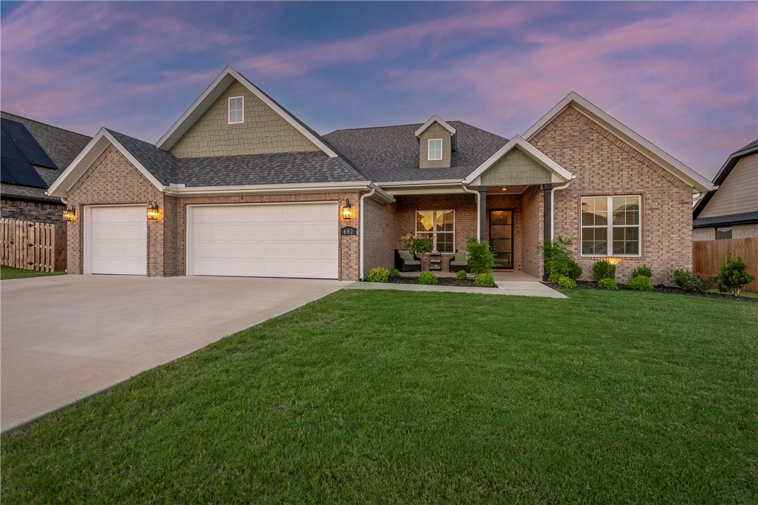 Unparalleled comfort and a flair of drama loaded with high-end finishes and useful amenities. Out front, amanicured lawn, 3-car garage, and covered porch frame a metal and glass door. The foyer gives a first lookat the open floor plan and showcases the floor-to-ceiling brick fireplace in the open living area. Slidingbarn doors lead to a home office full of built-ins. The kitchen is fitted with a gas cooktop, granitecountertops, slate blue cabinetry, big pantry, and stainless appliances. The raised ceiling in the breakfastnook is framed by dark beams above a wall of windows overlooking a fenced back yard. Imagine the spaceafforded by 4 bedrooms, 3 full baths, and upstairs bonus room. The primary bath is a fan favorite, with itssoaking tub, chic design, and tile shower. Bonus: with only one owner, all the appliances and systems arebasically new! Located just behind the Tontitown Winery near Har-Ber High School, tucked away in thepeace and quiet of Napa subdivision. Stop by the Open House Sat Aug 19, 1:00PM-3:00PM.