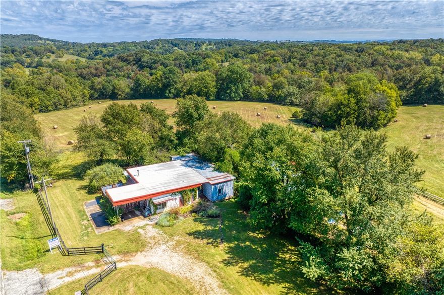 Beautiful, 36-acre farm located just 14 miles east of downtown Fayetteville and, in the McNair/Vandergriff school attendance zones. The primary residence is a remodeled loft style mid-century Conoco service station with a Pacific Energy woodstove. Could be an air-bnb, ultimate man cave, or artist’s studio with room for all your toys. The screened-in porch and front patio are perfect for entertaining. The fully furnished separate guest quarters above the barn has been a comfortable family retreat, successful air-bnb, and most recently a long-term rental property. Live in it, or the Conoco while building your dream home. Below the guest house is the four-stall barn, which includes a tack room, and covered tractor parking. The entire property is fenced and crossed fenced. A year-round spring fed creek flows through the property directly into Brush Creek. Many amenities make this farm perfect for horses and cattle. Abundant wildlife. Suitable for development with frontage on both Highway 45 & Edgewood Road to the east.