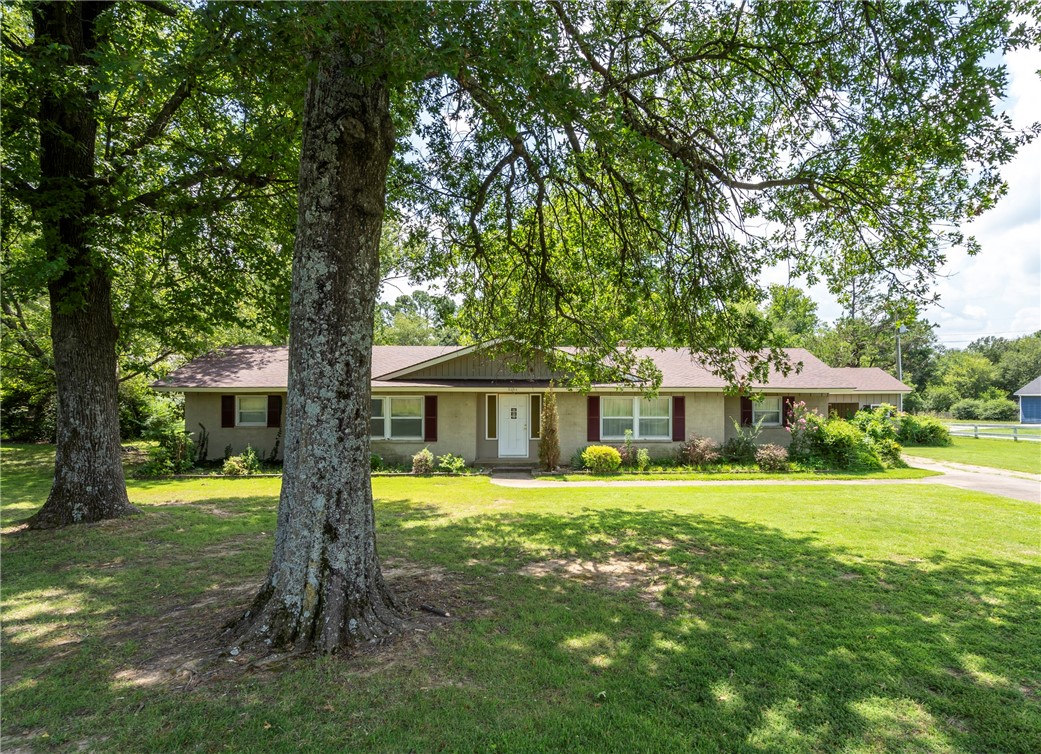 Charming ranch-style home on a spacious 1-acre, tree-shaded lotāperfectly situated across from the beautiful campus of John Brown University! This inviting single-story residence features a classic brick exterior with attractive shutters and a welcoming gable entryway. Inside, large windows fill the home with natural light, creating a bright and airy atmosphere throughout the comfortable floor plan. Perfect for both relaxing evenings and lively gatherings, the home offers generous living spaces and a cozy front and back porch to enjoy the tranquil surroundings. The expansive yard is ideal for gardening, entertaining, or simply unwinding under the shade of mature trees. Ideally located near schools and downtown, youāll enjoy quick access to shopping, dining, entertainment, parks, and the local amphitheater. Newer windows and stainless appliances. This home is ready for updates & renovation to make it the perfect home to blend comfort, charm, and an unbeatable locationātruly a must-see!