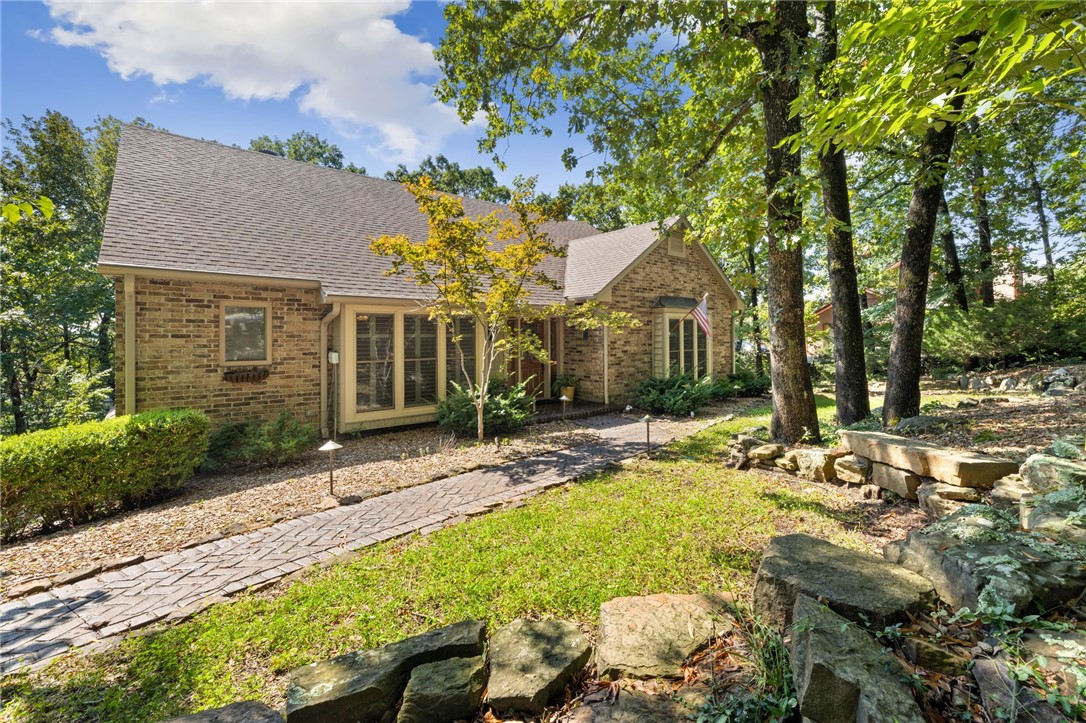 Welcome to the charming Treehouse in Hyland Park, hitting the market for the first time since its original build in 1987. Full of character and timeless appeal, this unique home sits on a wooded 0.60-acre lot with seasonal views overlooking Mount Sequoyah, offering a rare blend of privacy, nature, and convenience in East Fayetteville’s Hyland Park Subdivision. Inside, you’ll feel instantly at home with inviting spaces and thoughtful updates. The remodeled kitchen shines as the heart of the home, while details like plantation shutters, beautiful hardwood floors, and new insulated garage doors add modern comfort. Step outside to enjoy the beautiful deck, perfect for soaking in the wildlife and peaceful surroundings. The detached shed outside is another feature to highlight. It has electric and laminate flooring giving you versatile space for hobbies, storage, or a workshop. This property is truly one-of-a-kind—full of charm, nestled in nature, and ready for its next chapter.