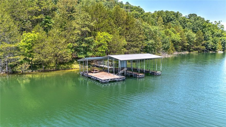 Motivated seller. Priced below appraisal. Private boat dock with two slips and swim deck. You’ll love this custom-built log home with breathtaking views of Beaver Lake. Spread across two lots totaling 1.71 acres, the property offers a unique connection to the outdoors, perfect for water enthusiasts and those that love nature. As you enter the home, you’ll discover a spectacular cathedral ceiling showcasing tongue and groove wood planking as well as brand new wood flooring. The heart of the Family Room is a gorgeous wood-burning fireplace accented with stylish copper flashing and a convenient toggle switch to set the mood. Prepare meals with ease in this generously-sized kitchen featuring extensive countertop space and storage. The home consists of 3 BR’s, 2 Full BA’s, 2,120 SF, a Bonus Room and wrap-around porches. The demand for lakefront homes with private boat docks is high. This is your opportunity to start creating lasting memories with family and friends right from your doorstep.