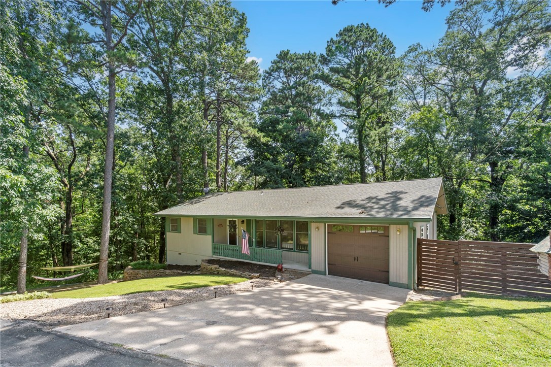 Freshly renovated with a unique and eclectic vibe, this 3 bed, 3 bath Bella Vista home offers 2,488 sq ft of versatile living. Enjoy dual primary suites—one on each level. The lower level features a wet bar, extra dry storage, a large walk-in closet, and a spacious flex space ideal for a second living area or office. Upstairs, natural light pours in through a skylight and a window-lined dining area that feels like a sunroom. The main floor boasts an open layout and a newly updated kitchen with new countertops and a renovated guest bath shower. Tucked away on a quiet cul-de-sac near Bella Vista’s ever popular biking trails, the property also includes an adjacent lot with an acceptable offer—offering extra space or future potential. A blend of character, comfort, and adventure! Schedule your showing today!