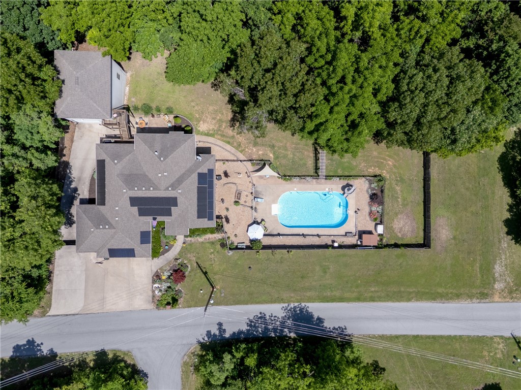 This beautifully landscaped property is designed for those who love to host, relax, and enjoy the outdoors with a rare, mostly flat, double lot totalling 0.66 acres! Step into your private backyard retreat, featuring a sparkling, in-ground pool surrounded by a spacious concrete patio—perfect for unforgettable gatherings or peaceful evenings under the stars. The two-story detached garage is a true showstopper, offering RV parking and hookups, a versatile workshop, and a second-story deck that connects directly to the home’s back deck, creating seamless flow for indoor-outdoor entertaining.
Pet lovers will be delighted by the thoughtful amenities, including a built-in dog bath, custom dog kennel, and a unique catio—making this home as welcoming for your furry friends as it is for your guests.
Northwest Arkansas offers an unbeatable combination of natural beauty, outdoor recreation, cultural richness, and economic opportunity. A place where you can enjoy peaceful living and exciting possibilities.
