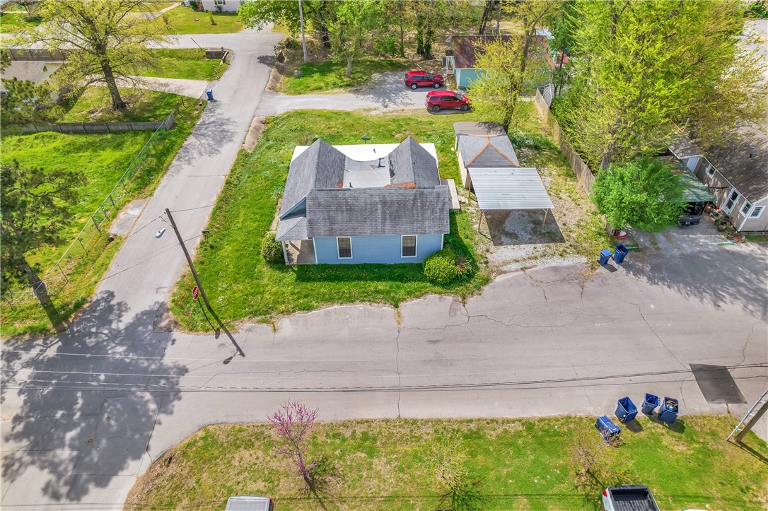 Whether you're a seasoned investor looking to expand your portfolio or a newcomer seeking a promising venture, this property offers a prime chance to make your mark in the thriving real estate market. The property is zoned R24, allowing for a variety of potential development options such as townhomes, apartments, or other residential or mixed-use projects. A newly added subfloor enhances the property's foundation, adding to its value and potential. Surrounded by mature trees and lush landscaping, it provides a peaceful retreat from the hustle and bustle of city life. If you're seeking a place to call home or an investment opportunity in a sought-after location, this property offers endless possibilities. Don't miss your chance to own a piece of history in the heart of Siloam Springs