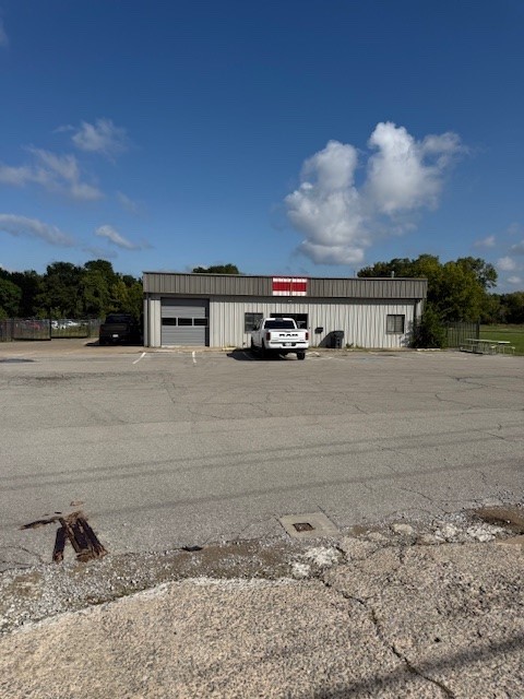 Corner Lot, High traffic flow! Frontage along HWY 62, building on almost 1 acre with a fenced in back lot. 3 garage doors, 4 bathrooms/2 showers, 2 heated/cooled office areas.