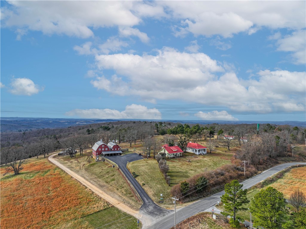 A rare opportunity to own a historic gem in one of the most coveted neighborhoods in Eureka Springs! The property known as Hillspeak spanning over 34 acres is rich in history! The main 10,000 sq ft iconic red barn was a true dairy barn prior to becoming the main printing and processing location of the "Anglican Digest" accompanied with a small beautiful chapel. The time has come to have a new dream brought to life with endless possibilities on this magnificent property featuring 5 living units (former rentals) in addition to the main barn. There are also multiple outbuildings for shop space, storage, etc. A large community well that serves the local neighbors is maintained on site. This property is truly a one of a kind and needs to be toured to fully appreciate the opportunity that exists here. Showings by appointment only to pre-approved buyers.