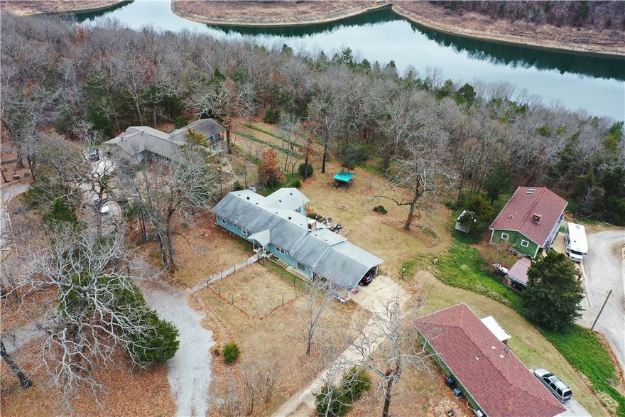 Beautiful lakeview 4 Bedroom 2 Bath home on Bull Shoals Lake with property backing up to Corps Line.  Updated kitchen, large dining area with a living room that adjoins the family room with a cozy fireplace.  Lower level has bedroom, fireplace and laundry. Plumbing has PEX and ABS were installed in 2022. 2 car oversized covered carport and lower-level utility garage with workshop area.