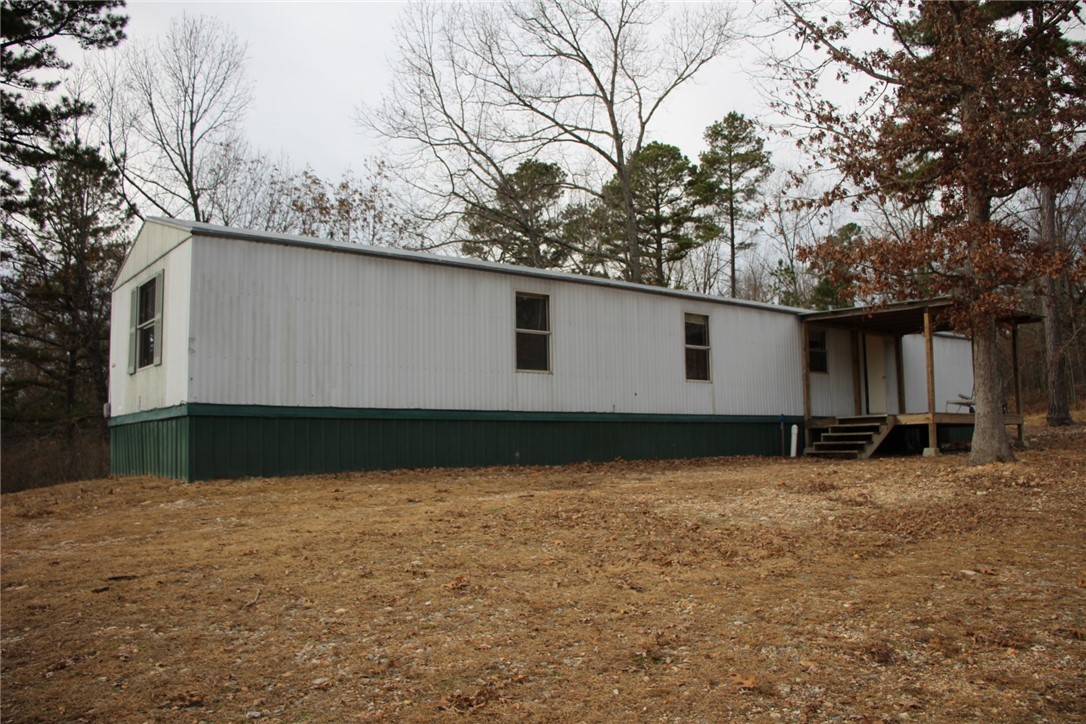 Single wide mobile home with 3 bedrooms and 2 full baths. Country setting on 6.18 acres only 8 miles to town. Large covered deck and open floor plan. Only miles from Buffalo River for fishing, boating and swimming.