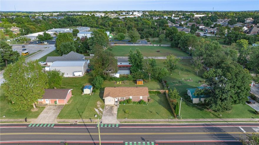 Come home to midtown Rogers. Zoned Neighborhood Medium-Intensity. Bike to work or work from home. Convenient to trails, parks, schools, shopping and restaurants. Brick house is on the bike trail, minutes from Miller Place Park, New Hope Park and Twin Creeks Disc Golf Course. New roof and new external wiring. Large kitchen with wood cabinets and ceiling fans. 3 bedrooms, one with a large walk-in closet, and 1.5 bathrooms. Lots of natural light with added sidelights on the backdoor plus 2 bonus rooms for bike racks, pantry, hobby or storage space. Neutral paint with updated LVP in the living areas and original hardwood floors in the hall and bedrooms. Large, partially fenced backyard with new 10x8 shed.