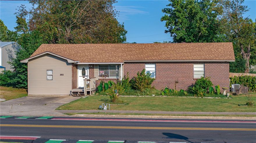 Come home to midtown Rogers, convenient to trails, parks, schools, shopping and restaurants. House is on the bike trial, minutes from Miller Place Park, New Hope Park and Twin Creeks Disc Golf Course. 1970s brick-ranch features 3 bedrooms and 1.5 bathrooms. Large kitchen with wood cabinets and ceiling fans. Lots of natural light with 2 bonus rooms for additional living, hobby or storage space. Neutral paint with updated LVP and original hardwood floors. Large, fenced backyard with new 10x8 shed. New roof and external wiring. Seller to make no repairs, inspection allowed.