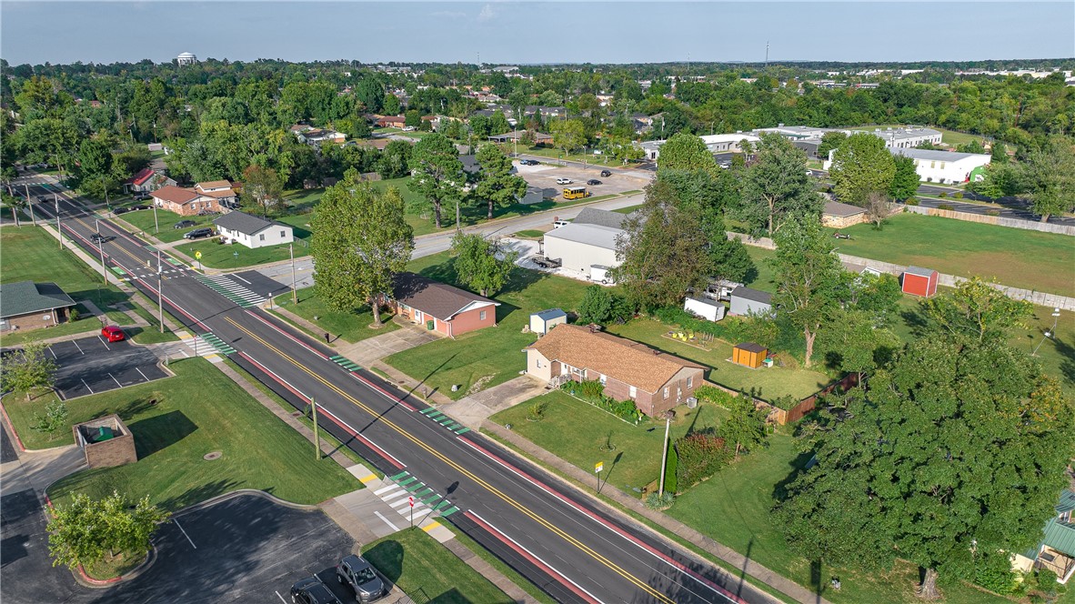 Come home to midtown Rogers, convenient to trails, parks, schools, shopping and restaurants. House is on the bike trial, minutes from Miller Place Park, New Hope Park and Twin Creeks Disc Golf Course. New roof and external wiring. Brick, ranch-house with 3 bedrooms and 1.5 bathrooms. Large kitchen with wood cabinets and ceiling fans. Lots of natural light with 2 bonus rooms for additional living, hobby or storage space. Neutral paint with updated LVP and original hardwood floors. Large, fenced backyard with new 10x8 shed.