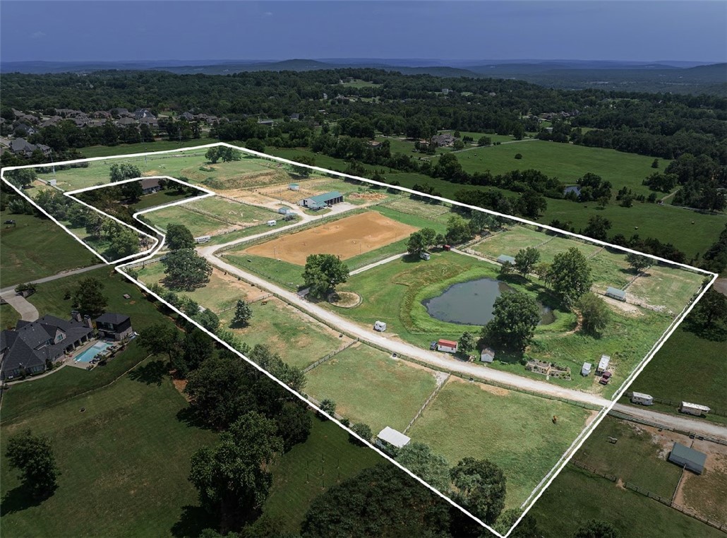 Prestigious location in NE Fayetteville area. Gorgeous 11 acres with operating Equestrian Center at present time. Several estate size building sites with views for miles. Adjoining Parkerman Estates and Sloan Estates. 8" water line. Clubhouse with shop area and 8 horse stalls. Several horse paddocks with shelters (which can be removed at buyer's request at no cost). Outdoor arena (2). Can be divided, ask agent.