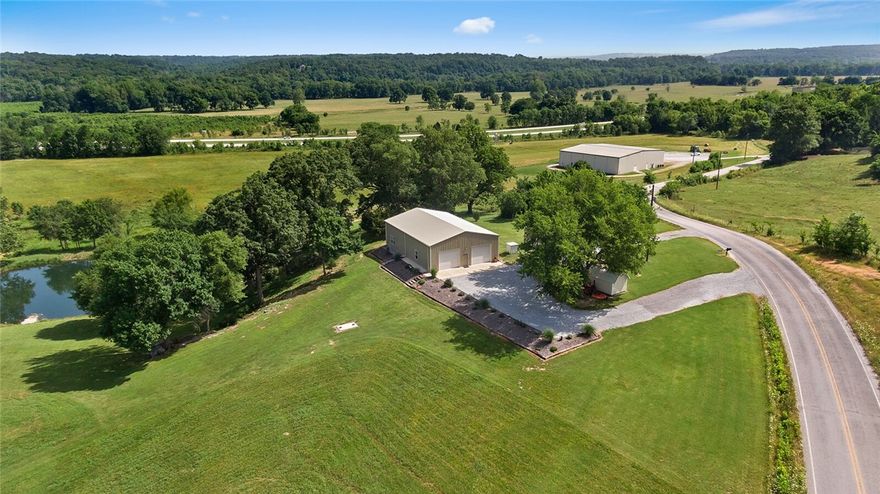 STUNNING 36.84 acres, park-like setting that has been immaculately taken care of! Fully insulated 40x60 "Shouse" built in 2020 with finished living space including granite and LVP flooring! 1 bedroom with 2 full baths. Living space can easily be adjusted to new owners needs with the wide open garage. Additional 20x10 shed. Spring fed, stocked pond. Spring water runs out of cave in old cellar into the pond, its a MUST SEE!! Hop, skip and a jump from the Ozark National Forrest! Property has RV pads that are income producing! Close enough to the Illinois River to walk, fish or kayak the day away! So many opportunities for this property!  Many extras can be included....ask for details. Also listed under ML 1222084