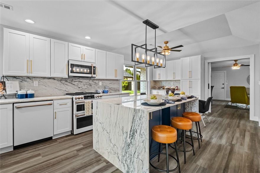 Fully renovated and truly move-in ready, this 4-bed, 3-bath one-level home is located in the gated Pinnacle community within the Bentonville School District. The home has been completely updated, including a new roof, Andersen windows, all-new flooring, custom cabinetry, designer lighting, and high-end fixtures throughout. The eat-kitchen is entirely new and features a waterfall island, modern finishes, and a built-in coffee bar, opening seamlessly to the main living space. Bright, open living areas overlook a flat, private backyard ideal for entertaining or everyday use. The primary suite includes a spa-style bath, while secondary bedrooms offer walk-in closets and thoughtful finishes. A large bonus room provides flexibility as additional living space or a 4th bedroom. Convenient to shopping, dining, I-40, the amp, hospital, office park, and nearby trails, it offers both privacy and accessibility.