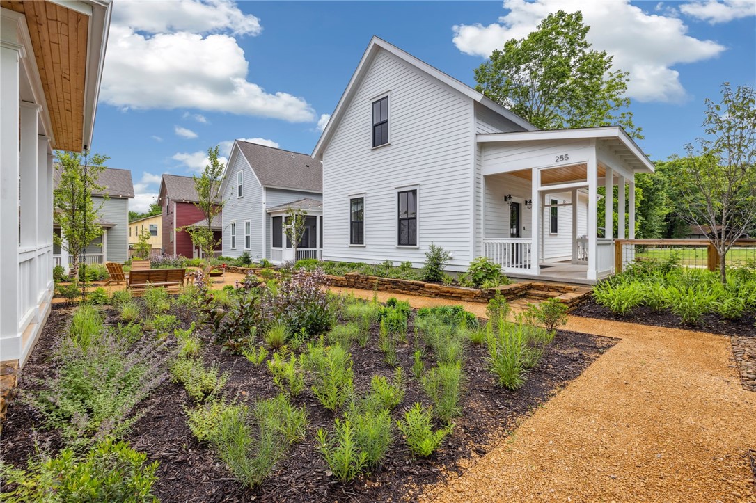 If a brand-new Net Zero home in a quiet and friendly Fayetteville community sounds appealing, you must see this one! This fully solar home is situated in the walkable/bikeable 11th Street Cottages neighborhood, surrounded by lush native gardens. Camber Cottage features primary suites upstairs and downstairs. The contemporary design boasts a spacious living room, tall ceilings, ample natural light, open-concept kitchen, generous prep space and induction cooking. Additional highlights include custom cabinetry, tasteful built-ins, and designer fixtures. The roomy screened-in front porch overlooks the common gardens and provides an outdoor living room. Private courtyard w/ direct access to private parking. ENERGY STAR certified high-performance systems with three-zone temp control for maximum efficiency, comfort and healthy indoor air quality. SunPower Equinox solar system w/25-year warranty. Call for more information about the neighborhood and available floor plans!