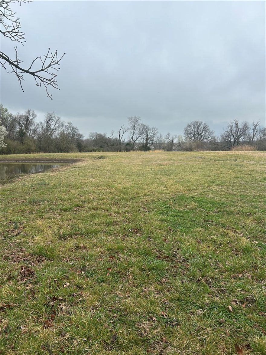 Level 5 acres in north Springdale with development potential.  Centrally located with utilities nearby, this property could be divided into multiple lots or enjoy your own private estate with remodeled home.