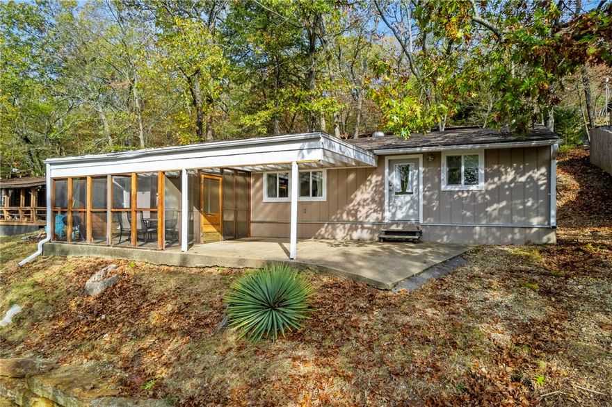 Enjoy the lake life and charm of Lost Bridge Village! You will love this cozy, updated cabin that is being sold fully furnished. Park your boat out front, unload your bikes & lake toys, and make yourself at home as you enjoy the peace and nostalgia of Lost Bridge Village. This adorable cabin features an open kitchen and living area with a dining nook & island seating. Relax in the bright and open living room after a day on the water. There are two bedrooms and a large (newly added) bunkroom for sleeping. Enjoy dinners outside in the screened-in porch as you watch the sun set and deer graze. Stroll down to the park, pool, & community center and enjoy the lake from there or the shoreline behind the community center. Play pickleball or tennis on our brand-new courts! Got a plane? Fly in and land on the LBV airstrip. Only 3 miles to Lost Bridge Marina. Short drive to Rogers, Pea Ridge, & Eureka Springs. Don't miss this great opportunity- they don't come around very often at this price!
