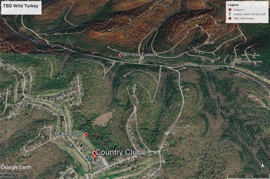 Lots of road frontage on this lot sloping down from the road. Close to the main entrance, golf course and country club of Holiday Island.