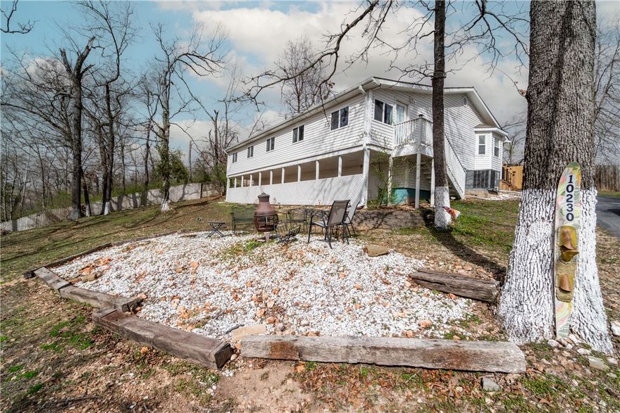 Charming 3-bedroom, 2-bathroom home on 0.51 acres with seasonal Beaver Lake views. The enclosed front porch, converted into a 4th bedroom, offers a mini-split for year-round comfort. Inside, enjoy an updated kitchen with quartz countertops, a new backsplash, and modern appliances. The living room features a cozy wood-burning stove. Recent updates include a newer HVAC, water heater, and energy-efficient windows. Both bathrooms have been beautifully renovated. The covered back porch is perfect for entertaining, plus there are two carports, a storage shed, and more. This turnkey home is ready to move in!