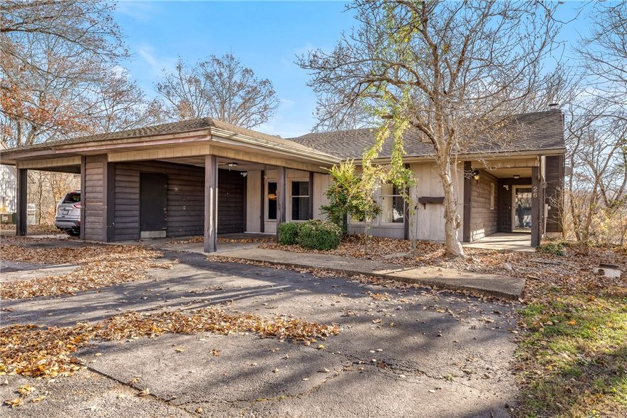 Golf Course Views + Trail Access = The Ultimate Bella Vista Lifestyle! This light, bright one-level townhome gives you an open floor plan, a cozy fireplace for winter nights, and a deck made for entertaining.  Overlooking the 16th green at Kingswood Golf Course, Little Sugar Creek, Sugar Creek Bridge Trail & Danger Will Robinson Trail.  Relax on the back deck with morning coffee or host friends as the sun sets. Convenient attached carport.