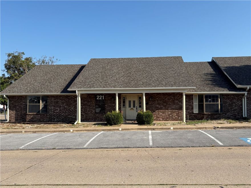 Opportunity to own a prime corner office building with 14 parking spaces! Located in Downtown Rogers City Center across from Arvest Bank & City Hall. Zoned T5.1 Town Center. The all brick 2,717 square foot building is in excellent condition with new roof & guttering summer 2025 and fenced back green space area. Includes floor plan of lobby area & reception, break room w/kitchenette and central conference room surrounded by seven individual offices.