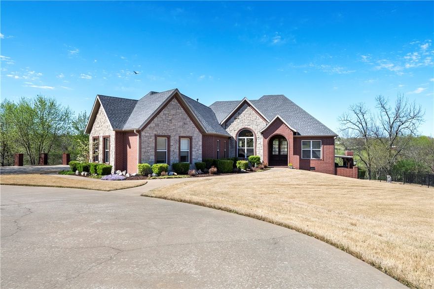 EXQUISITELY DESIGNED brick/rock home w/4bedrooms/3 bathrooms nestled on 4.48 acres on a cul-de-sac. This home has it all! The foyer flows into the elegant living room & dining room captivating outdoor views with impressive windows, fireplace, built-in cabinetry, crown molding & craftsman details. Transition to the family breakfast room with access to outdoor balcony space for dining & entertaining amid the serene surroundings.  Enjoy sitting out under large covered patio w/ wood burning fireplace & lovely private back yard with pool.   Lower level 2nd living area has a office, wall to wall shelves & 4th bedroom/Bathroom perfect for watching a movies. Oversized 3 car garage & detached two car garage/work shop. The home has views out the windows & peaceful serenity of country style living with in the city limits. Great place for family to live and swim outdoors.  Great place to have animals and pets.  This home was owned/built by the builder. This home has been loved by it's owner which reflects "pride of ownership".