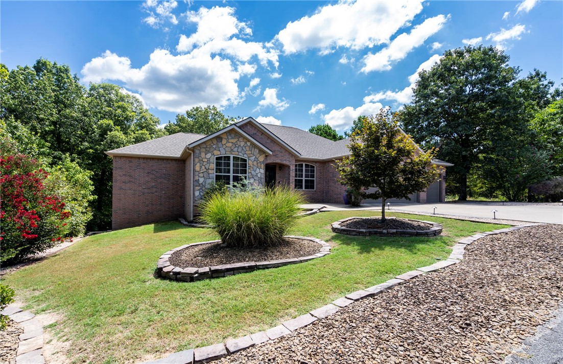 Life sometimes presents unexpected surprises, and this beautiful home is once again on the market. The sellers had planned to stay for many years and have made many updates. This lovely 3-BR, 3.5-BA home now boasts new carpet on the lower level, professionally painted walls, trim, and ceiling, & a newly installed home theater. In the past 3 years, the roof was replaced with extra durable shingles, the carpet was swapped for hickory hardwood floors, and Trex decking added to the upper deck. The 1st floor features an open concept with 2 ensuite bedrooms, a dining room, office & a spacious kitchen perfect for gathering with family and friends. The lower level includes a home theater, a 3rd BR & BA, a wet bar, & a large shelved storage area or workshop. This move-in-ready home is adjacent to Scottsdale golf course, close to Stoneykirk boat ramp & walking trails. The nearly level lot backs up to a wooded POA area and is adjacent to privately owned wooded acreage. Covered patios provide access to secluded outdoor living.