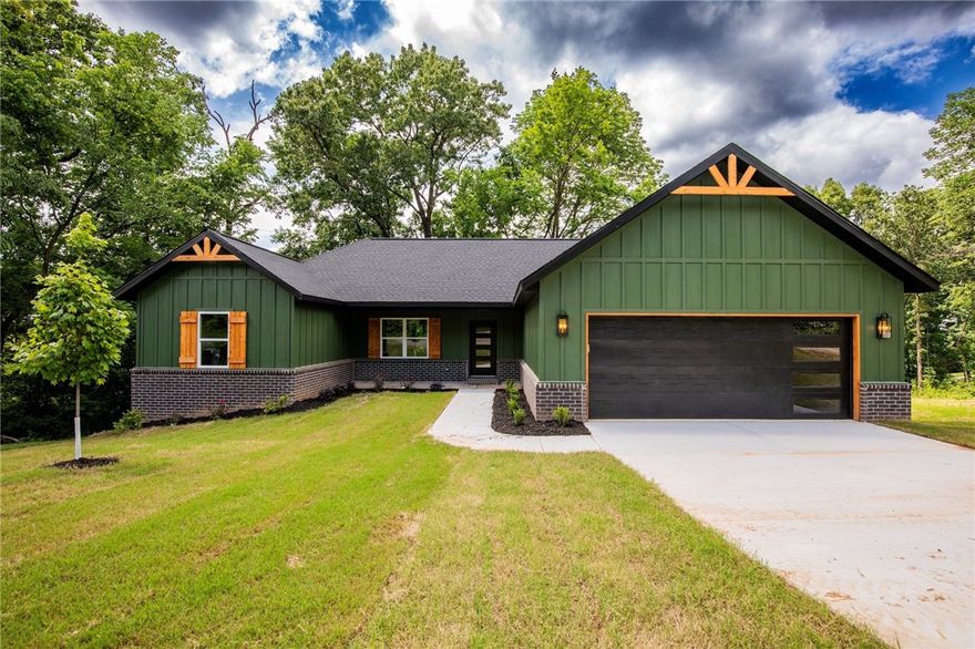 Come experience all the amenities Bella Vista has to offer, which includes seven golf courses including a world class practice facility, seven private lakes, miles of hiking and biking trails, swimming pools, a beach, parks and much more. This gorgeous three bed, two bath secluded home offers tons of upgrades like wood beams on the vaulted living room ceiling, electric fireplace, gas cook top, unique granite, beautifully painted custom cabinets, wood flooring in the main areas including the primary suite, large soaking tub and walk-in shower in the primary bath. There is a pre-wired blank outlet in garage for EV. Relax on the covered back deck.