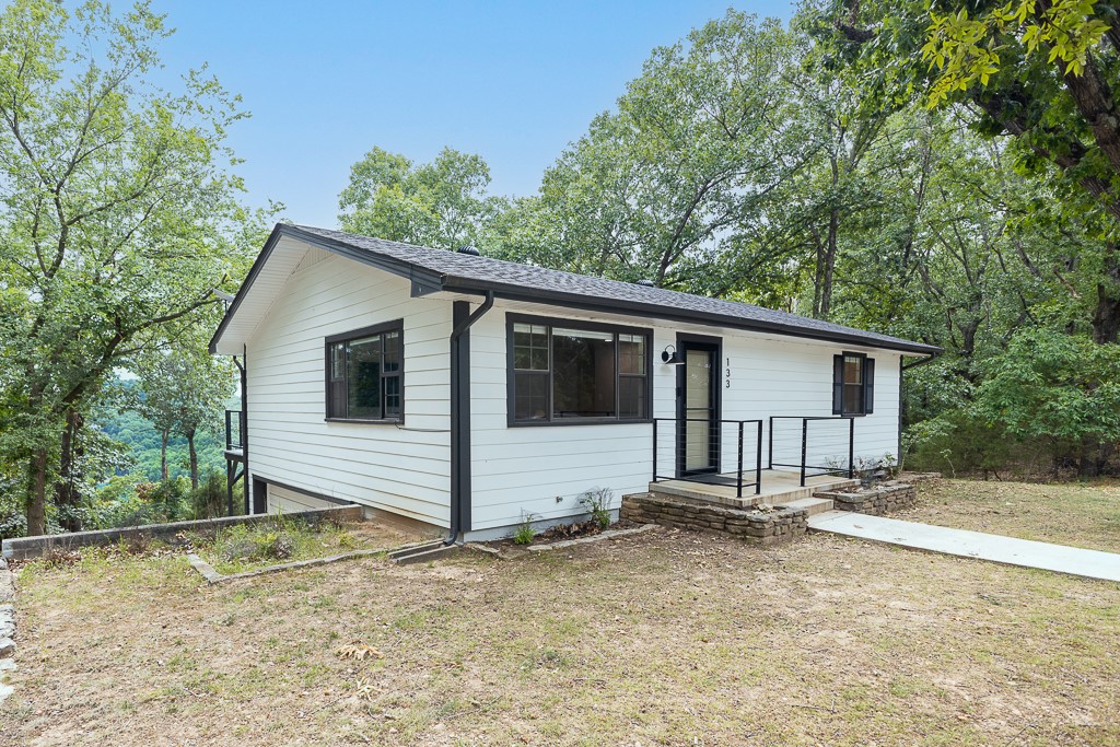 Year round lake view in this stunning like new home near to Starkey Marina! Gorgeous wooded tree house like setting on the hillside by Beaver Lake, store your kayaks under the back deck where you spend time grilling, watching the deer and birds, and enjoying sunset every day. Home is on a quiet road with a two-car temperature-controlled garage for parking below the house. Flooring is like new LVP, the windows are in great shape, the paint is like new, appliances are stainless steel, with stackable washer and dryer space. Two bedrooms are upstairs and one larger bonus room is downstairs with sliding barn doors. It also has an energy-efficient whole house heat pump with backup electric heating and whole house water filter. Near to the Lake Leatherwood Gravity Project and Thorn Crown Chapel. Bike in/bike out on gravel roads! Near to guided fishing tours, boat rentals, Turpentine Creek, and around a 20 minute drive to Eureka Springs. Furniture is negotiable.