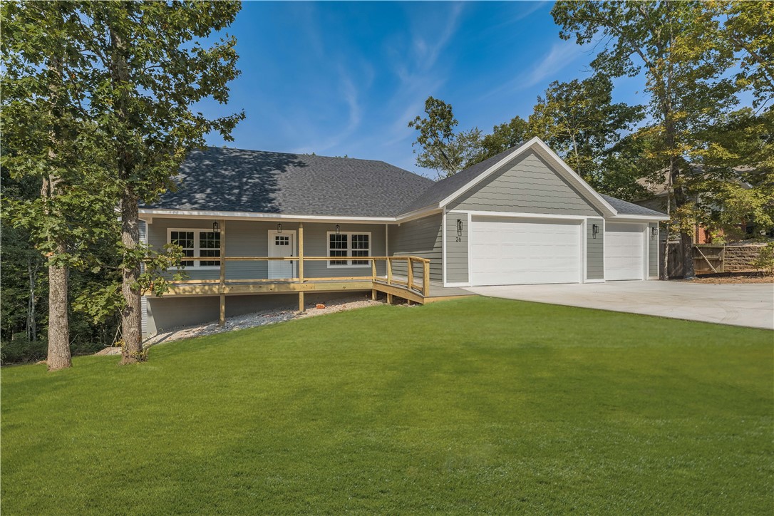 This breathtaking farmhouse style with open floor plan is a must see, just near Blowing Springs and It'll Bluff Out trail in in the backyard! From the eye-catching front porch, you enter & are greeted with towering ceilings, & a wealth of natural lighting in a large main living area. There are many high end features, beginning with the beautiful light wood LVP & cathedral height stone fireplace. As you continue through the home, you will find the spacious kitchen with tons of cabinet space, stunning oversized island open to eating & main living. From here you can wander to the back patio, overlooking a gently sloped beautiful back yard with trees. The spacious owners retreat features huge closet and a spa-like walk-in shower. Off the kitchen there is a half bath and an oversized, dreamy, laundry, room with cabinetry and access to the owner's closet. Nearby is the handy half bath for guests or quick stop from the outdoors. All this so close to Bentonville and Bella Vista shopping & Trails as well as Walmart HQ