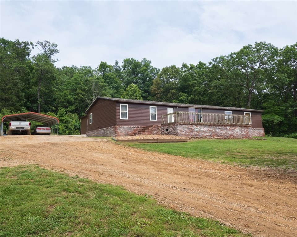 Peaceful country 3+ acres with a house big enough for the whole family! Nice level land perfect for gardening, chickens or building a shop or barn. The possibilities are endless, with an easy 20 minutes to Rogers and city conveniences. 30 minutes to Eureka Springs, and a hop and skip to lovely Beaver Lake! House has custom built-ins, and cedar work in the great room and bedroom. Bonus room can be finished as you wish! Come live in the country; and retire or raise your children near Beaver Lake in quiet Garfield Arkansas. New roof and air conditioning in 2019.