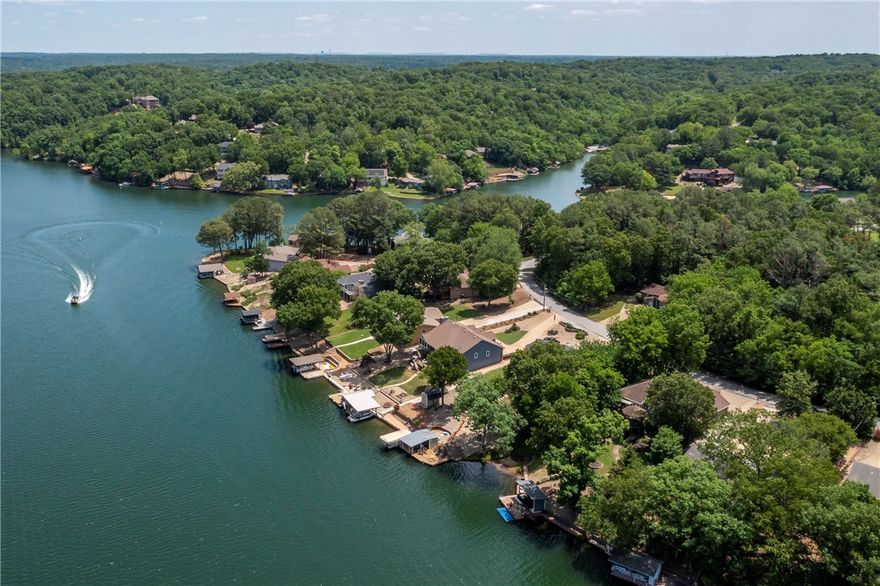 On Bella Vista's Lake Windsor with an easy walk to the private boat dock with lakeside covered bar & grill. Enjoy lake views from the gazebo patio & swim deck. Primary, second bedrooms with two baths are
located on the main level. Updated kitchen with quartz countertops, 5 bedrooms with 3 fully updated baths, home theater and swim-spa on lower level. Refrigerators, washer/dryer, swim-spa, tv's & generator convey. Fully furnished short term rental. Furnishings convey with an acceptable offer. Brewery equipment does not convey. See attachments.