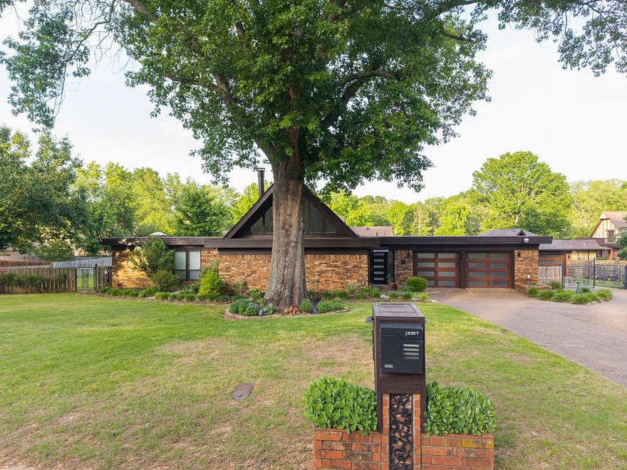 This exceptional, updated home is located in the heart of Fort Smith. Bathed in natural light, the modern residence features three downstairs bedrooms, each with its own full bathroom, plus a convenient half bath. The spacious living and dining areas create an inviting atmosphere, while the game room, also situated on the ground floor, is ideal for entertaining guests. Upstairs, a versatile bonus room serves as a perfectly quiet reading nook or office space. The home boasts new fixtures and adjustable touch lighting throughout. The updated kitchen is a culinary delight, featuring butcher block countertops, a black granite sink, a mirrored backsplash, and a double oven. A large utility room with a sink adds practicality to the layout. The oversized, fully privacy-fenced backyard offers a tranquil retreat, complete with a fire pit, lush landscaping, and landscape lighting. Additionally, the property includes a two car attached garage and a three car heated and cooled detached garage, enhancing its appeal.