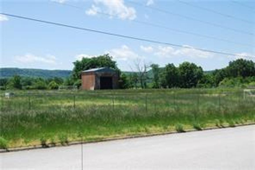 Vacant lot with 1 brick structure that is unused.   Lot is fenced and has been used as outdoor soccer field by church league. Lot is level with all city utilities available at street. Ready for your new business or hold for future development. Bypass US 62 southern option will put this property between existing US 62 and new bypass for easy access to you property. See MLS listing #