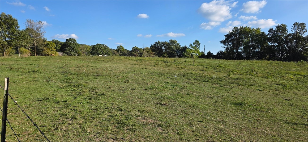 Nice 4.5 acres M/L of pasture with perimeter fencing, nice pond and good view.  Wonderful building site just off pavement with rural water available at the road.  Room for some livestock.  This property would make a great mini farm.