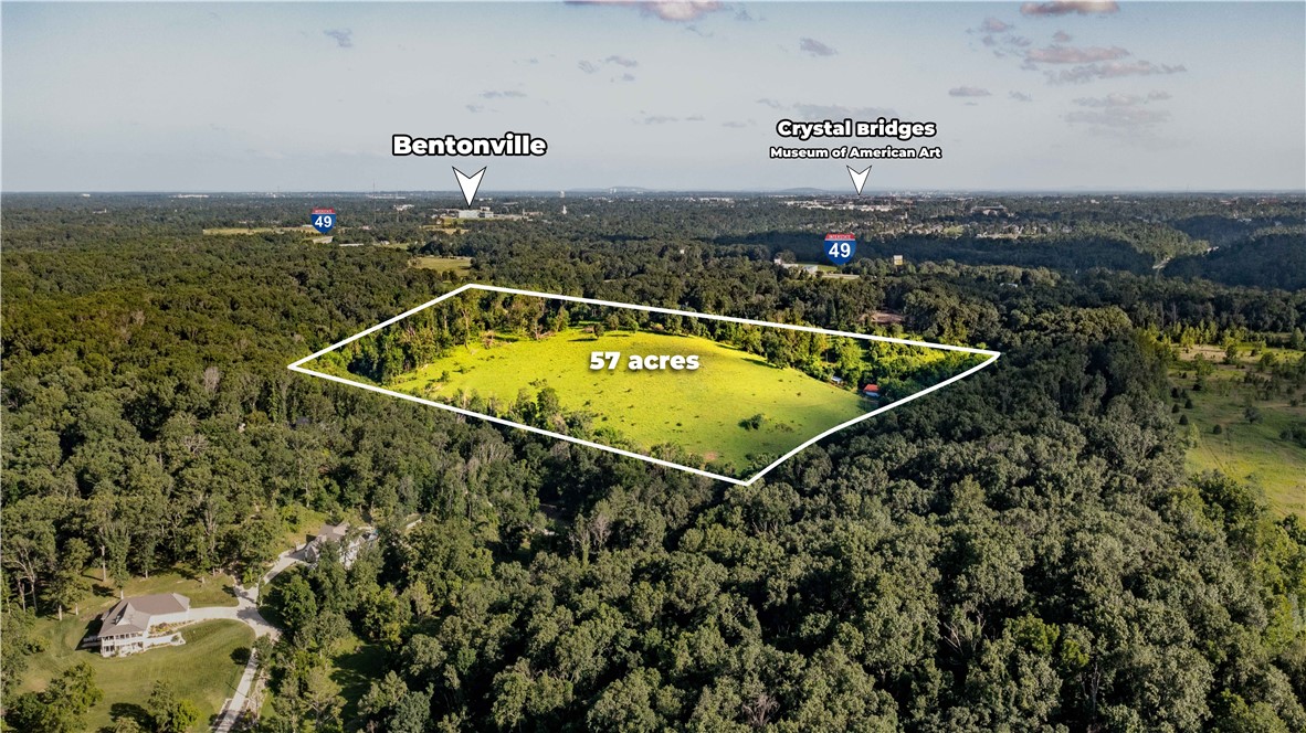 Opportunity awaits just beyond the Bentonville city limits! These 57 wooded acres offer a rare blend of privacy, proximity, & potentialāperfect for those with big ideas & bold visions. With no city zoning restrictions, you have the freedom to create without limitations. Surrounded by residential and recreationally zoned land, this property sits less than 4 bikeable miles from Crystal Bridges Museum, the AWSOM campus, & the iconic OZ Castle & Slaughter Pen MTB trails. The area is buzzing with development, making this a strategic investment in Bentonvilleās rapidly growing town. Imagine a luxury estate community nestled among the trees while remaining connected to the heart of Bentonville. Utilities: Electricity available at the street, propane for gas, suitable for standard septic systems, & well water needed. Located in the highly sought-after Bentonville School District. East Bentonville is ready for its next luxury communityācould this be the future site of your legacy project? Come experience it for yourself.
