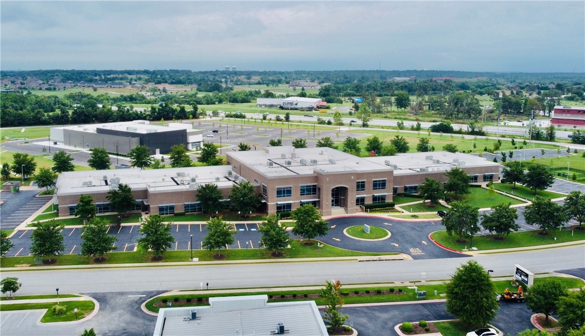 Exceptional investment opportunity with 3605 Southern Hills Blvd, Rogers, AR. This fully leased, 64,647 SF office building is fully occupied by two reliable tenants, ensuring a stable and reliable income stream. Included in this offering is Lot 23, an adjacent 1.18-acre unimproved lot, which will be sold as a package with the office building. Currently, the lot features a playground used by the tenant, Friendship Community Care.
The property is ideally situated directly off Interstate 49, providing excellent visibility and accessibility. Its location is further enhanced by its proximity to the rapidly developing Pinnacle area of Rogers. This area is witnessing an exciting phase of growth with several high-profile developments enhancing its appeal and utility. Notably, the Pinnacle Hills area is set to see significant advancements including the addition of the Pinnacle Heights mixed-use development featuring upscale residential units and retail spaces, and the continued expansion of the Pinnacle Hills Promenade.