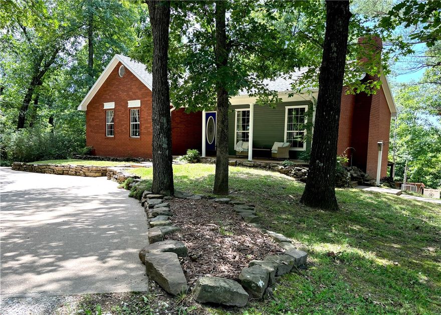 Come see this beautiful property on 10 acres an incredibly rare find for a Bentonville address. Enjoy this peaceful retreat with room to breath yet convenient to everything NWA offers. a true 5 bed 3 bath, two story brick home with a great layout. Eat in kitchen, wood burning fireplace, game room or second family room downstairs. Inviting covered front porch, wood deck and patio in rear. Two car garage, carport, and an impressive outbuilding. It is 20 x 40, two levels, oversized garage door/RV storage. On top of your outbuilding is a 24-panel solar system professionally installed by Shine Solar. New roof replaced April 2023. Bring your furry friends, the chickens are already waiting- small coop on property. Could be a nice hobby farm or accommodate a few horses. Wet weather creek down the hill, excellent hiking and hunting. Possible mountain bike trail expansion to rear of property. Acreage provides wooded and flat cleared land if ever want to subdivide. Home comes with a 1 year home warranty.