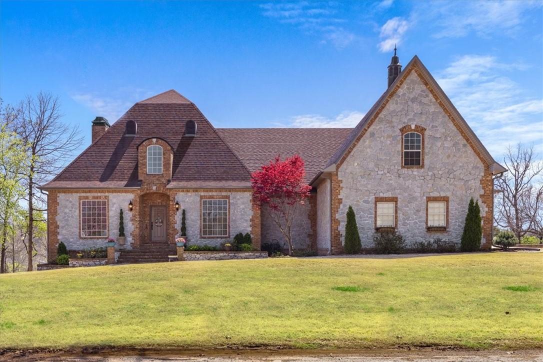 Nestled on 1.35 acres, this impressive 4-bedroom, 3.5-bath custom-built home has Year-round panoramic views of the White River and Beaver Lake As you step inside, you’ll be welcomed by elegant 20-foot ceilings, rich hardwood flooring, and stylish built-ins in both the study and formal living room. Spanning 8,268 square feet, this home boasts an expansive primary suite with generous his and her closets.The remodeled gourmet kitchen is equipped with a Cafe 6-burner range and a Cafe smart convection double oven, perfect for culinary enthusiasts open to living room that features a charming stone fireplace. Additional features include a convenient downstairs kitchenette, huge bonus entertainment room, a whole home generator, a large safe room, and a 4-car garage.
Recent updates; including a stunning kitchen renovation with new countertops, a sleek hood vent, and composite sinks, as well as a new HVAC system, a backyard fence, and modern ceiling fans in the bedrooms. Boat ramp is conveniently 5 min away