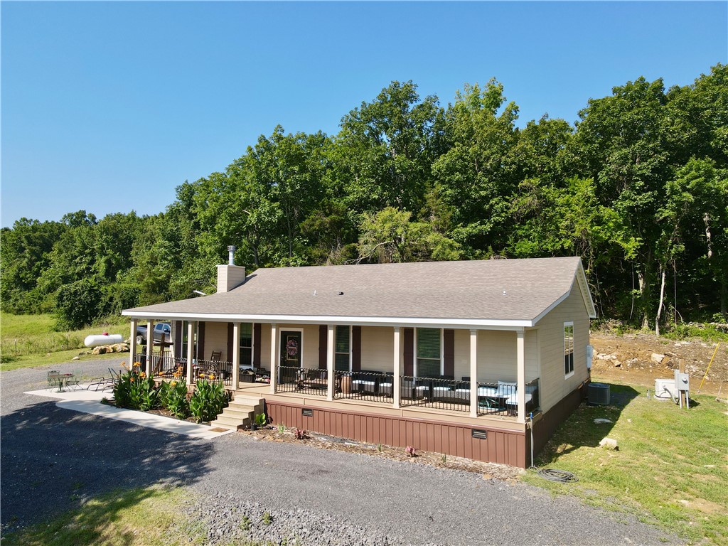Beautiful 76.75± acre property featuring a 2023-built 4-bed, 2.5-bath modular home, year-round spring, stocked ponds, and stunning views. Includes 25± acres of established pasture with the remainder in hardwoods ideal for hunting and recreation. Outbuildings include a 30x40 shop with living quarters and RV hookup, 32x32 barn with loft, lean-to, 7 stalls (with water, electric, and fans), 20x40 hay barn, chicken coop, and garden area. Also features an enclosed hunting blind overlooking a food plot. Perfect for homesteading, livestock, or a private retreat. The home also has a 26 kw Generac propane generator that will convey.