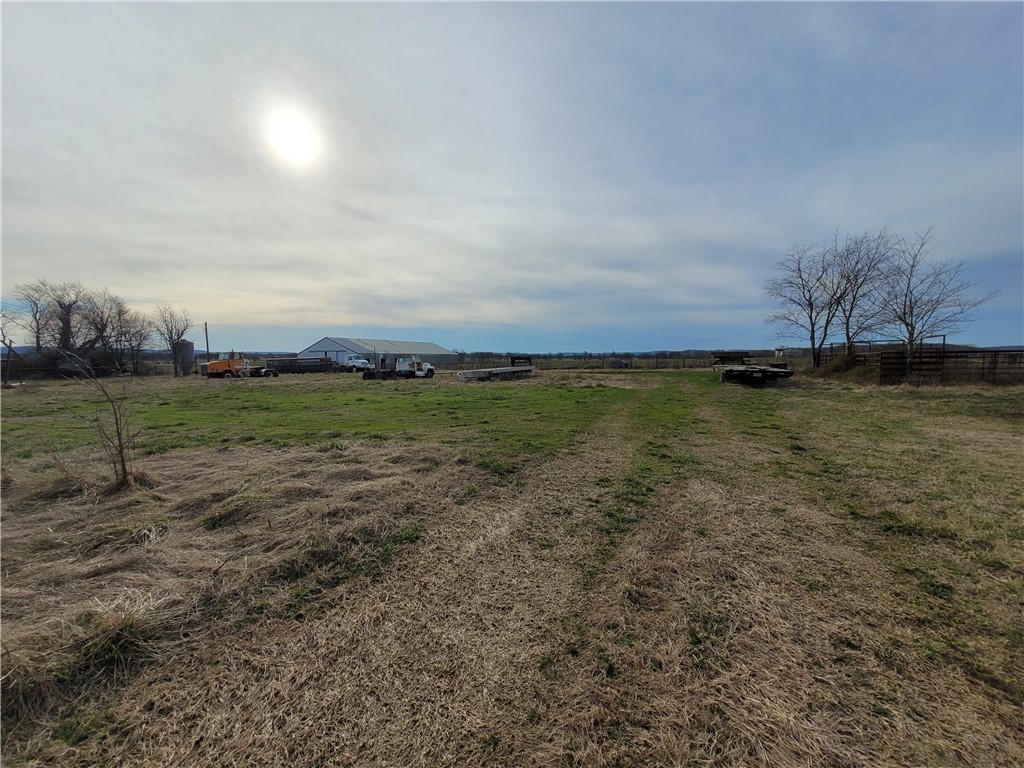Stunning 40 AC +/- tract in Prairie Grove only 9 miles from the I-49 & MLK exit. Gorgeous country views any direction you look. 2 spring-fed ponds make a great stopping point for the water fowl that pass through. Property is fenced. 5,000+/- SF metal barn/shop is set up with an iron corral. Would make a great homestead or perfect place for a development. Level cleared land you could build just about anywhere. House on the property has NO VALUE.