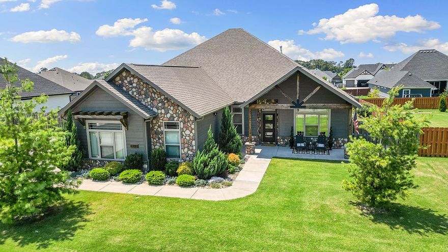 Modern Mountain Rustic home with stunning features throughout! You will fall in love with this one level, split floorplan. The primary suite offers a tray ceiling with pine accents, a luxurious custom tile shower with seating, and soaker tub. Vaulted living room showcases a stone gas log fireplace one of a kind projector for the movie watchers. Includes a dedicated home office. The extra-deep 28' garage fits a car, boat, or workshop setup. Kitchen features pantry, pot filler, gas cooktop and coffee bar area. Energy-efficient features include a tankless water heater, fully paid-for solar panels to reduce utility bills & Smart-home ready with Wi-Fi-enabled thermostat and irrigation controls. The covered patio is perfect for entertaining, with grill and fire pit connections. Fully irrigated yard and planters on a separate meter, all on a flat lot. Enjoy the saltwater pool, that's heated & an outdoor kitchen. 15 minutes to downtown Bentonville & Home Office and only 5 minutes to Bentonville West High School!