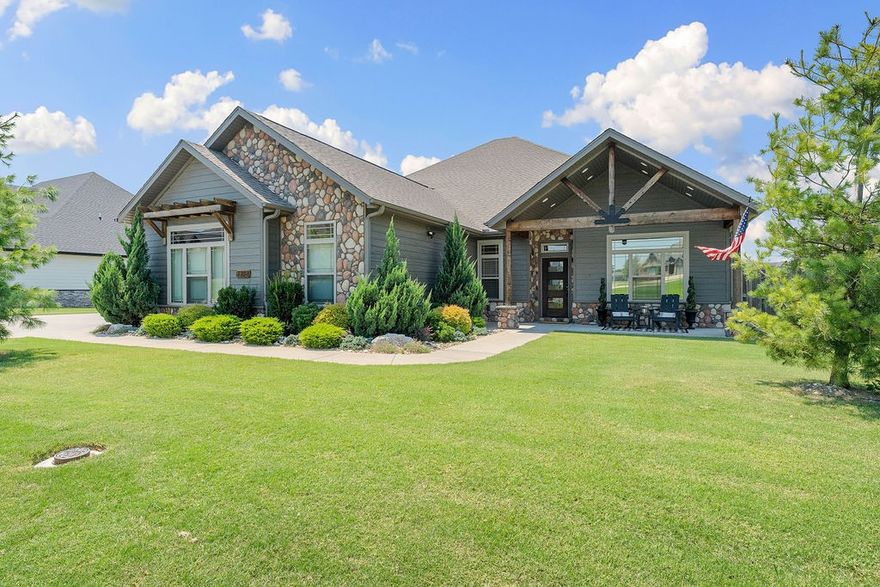 Modern Mountain Rustic home with stunning features throughout! You will fall in love with this one level, split floorplan. The primary suite offers a tray ceiling with pine accents, a luxurious custom tile shower with seating, and soaker tub. Vaulted living room showcases a stone gas log fireplace one of a kind projector for the movie watchers. Includes a dedicated home office. The extra-deep 28' garage fits a car, boat, or workshop setup. Kitchen features pantry, pot filler, gas cooktop and coffee bar area. Energy-efficient features include a tankless water heater, fully paid-for solar panels to reduce utility bills & Smart-home ready with Wi-Fi-enabled thermostat and irrigation controls. The covered patio is perfect for entertaining, with grill and fire pit connections. Fully irrigated yard and planters on a separate meter, all on a flat lot. Enjoy the saltwater pool, that's heated & an outdoor kitchen. 15 minutes to downtown Bentonville & Home Office and only 5 minutes to Bentonville West High School!