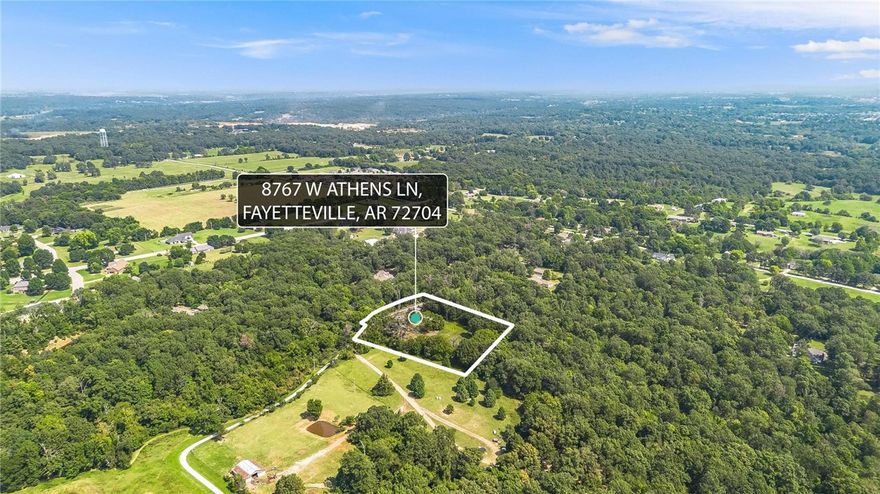 VALUE IS IN LAND. -This flat and ready to be built on land off Wedington offers secluded and peaceful country living just minutes from town—only 10 minutes to shops and dining, and about 20–25 minutes to downtown and the University of Arkansas. The manufactured home has zero value—offering a detached 10x20 garage, storage shed, woodshed, well house, carport, plus additional storage buildings (one 10x8 and one 20x20); nearby you’ll find Kessler Mountain trails, Lake Fayetteville, and the Botanical Garden of the Ozarks. Come put your vision to work, and make this one yours!