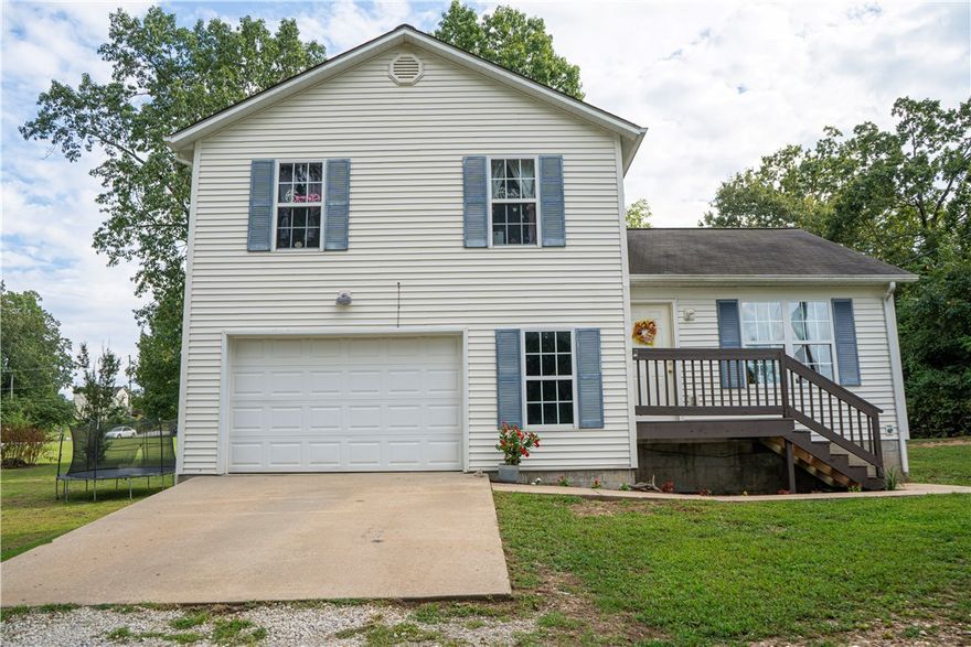 Spacious, bright, and move-in ready! This 3-bedroom, 2-bath home on nearly an acre offers the perfect mix of comfort and functionality! The open living area is filled with natural light , while the upstairs adds flexibility for playrooms, a home office, or guest suite! Enjoy a large yard with plenty of room for outdoor fun, gardening, or entertaining. With 3 bedrooms, 2 bathrooms, an attached garage, large yard, and a peaceful setting... this home checks ALL the boxes! 15 minutes from Harrison and only 5 minutes from the Western Grove School!