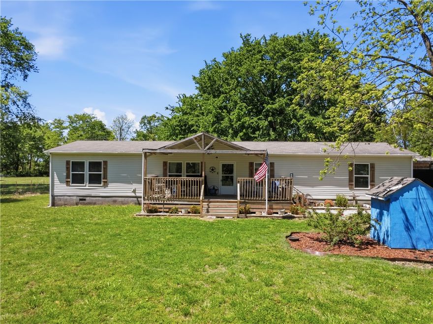 This spacious 4-bedroom, 2-bath manufactured home with a large shop is situated at the end of a private drive,on approximately 11 acres.  It offers both privacy and charm. The property combines comfort, functionality, and convenience, allowing you to enjoy peaceful country living just a short drive from town.