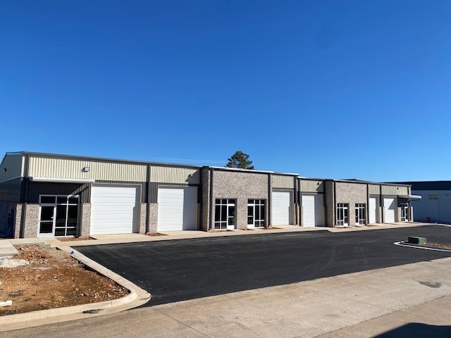 Newly constructed flex warehouse space in the heart of Springdale. Two grade-level 12' roll-up doors per bay with 18' sidewalls and ~ 21' peak height. Tenant has the option to design an office space and/or restroom(s) to suit their needs if necessary. This basic Tenant Improvement Allowance is included in the base rent. There could be additional cost for more extensive build-out. That cost is negotiable depending upon the level of finish out and lease term and would be added to base rent. This building has 5 total bays (bays are 1,920 sf & 2,100 sf) still available which can be divided or combined in several combinations depending upon what is still available at the time of lease. Lockbox on Suite A.
