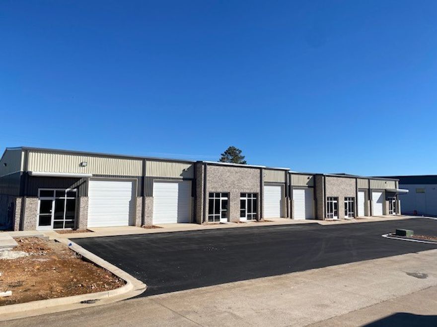 Newly constructed flex warehouse space in the heart of Springdale. Two grade-level 12' roll-up doors per bay with 18' sidewalls and ~ 21' peak height. Tenant has the option to design an office space and/or restroom(s) to suit their needs if necessary. This basic Tenant Improvement Allowance is included in the base rent.  There could be additional cost for more extensive build-out. That cost is negotiable depending upon the level of finish out and lease term and would be added to base rent. This building has 5 total bays (bays are 1,920 sf & 2,100 sf) still available which can be divided or combined in several combinations depending upon what is still available at the time of lease.  Lockbox on Suite A.