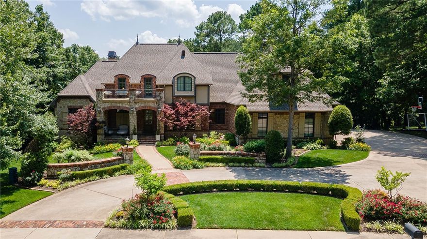 Timeless elegance meets elevated living in this European-inspired Parade Home, set on a professionally landscaped lot overlooking the 11th & 12th holes at Blessings Golf Course. Gourmet kitchen stuns with JennAir appliances, granite counters, travertine floors, & an island. Living room features soaring ceilings, custom mantle, & a striking two-story fireplace. Offering a peaceful retreat, the primary suite includes deck access, dual vanities, jetted tub, custom walk-in closet & two private water closets. Upstairs includes two ensuite bedrooms & a suite with kitchenette—perfect for guests or mother-in-law space—while the lower level adds a second kitchen with massive storage room off it, add. living area, theater room, gym, sauna & guest suite. Designed for entertaining, the outdoor space features a covered deck with gas fireplace, heated gunite pool with hot tub, outdoor kitchen & patios. Every inch of this 7,000+ SF home is curated for comfort, beauty, & seamless entertaining—where luxury meets everyday living.