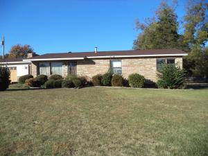SITTING FAR BACK OFF MAIN STREET ON 1.50 acres, sits this lovely cut rock and vinyl sided home. Formal living room, family room with fireplace, pocket doors, utility room with sink, tile floors in bath and large fenced backyard with small barn.